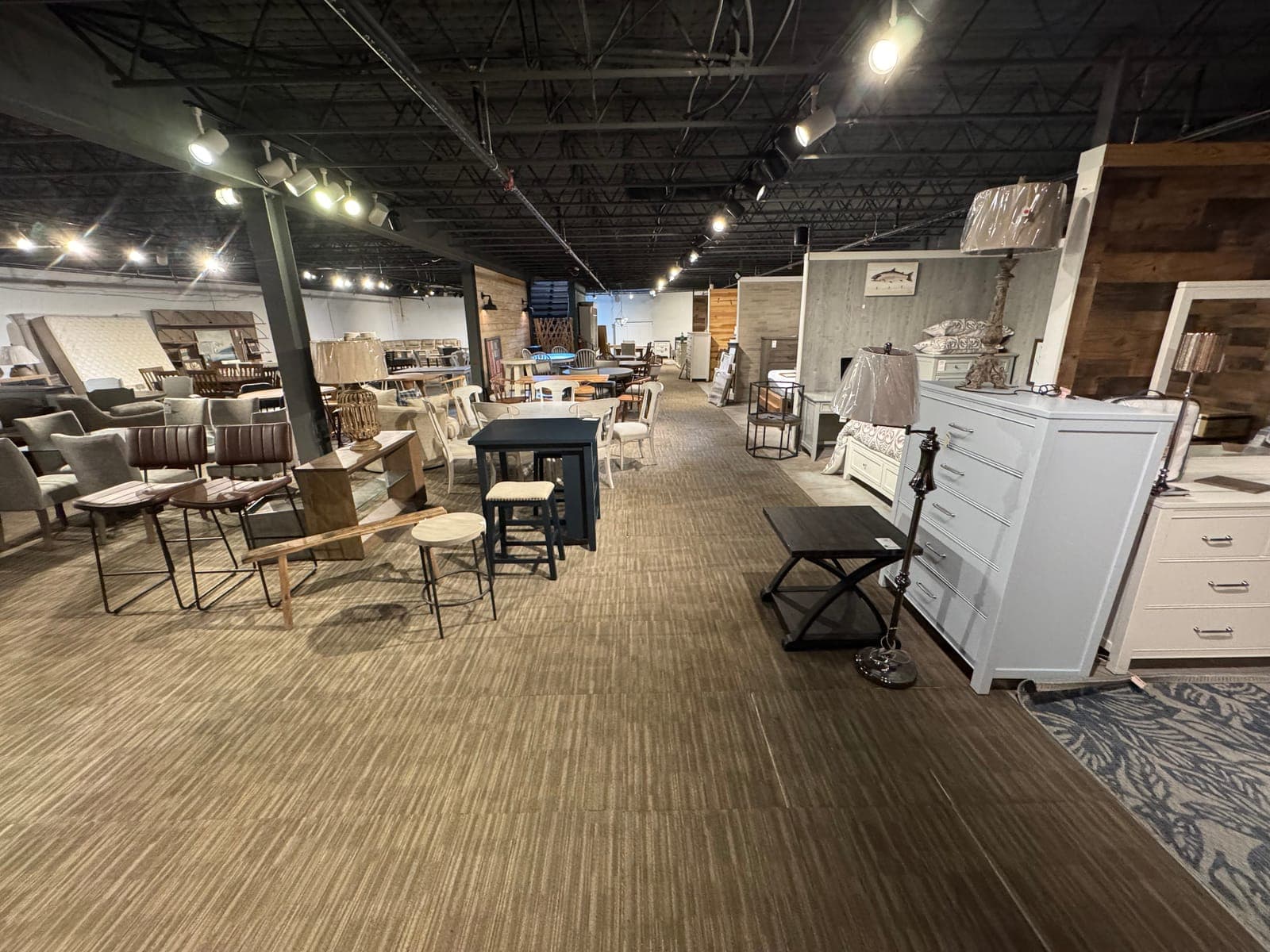 Dining tables, counter stools and bedroom furniture on the Seneca Furniture Showcase floor