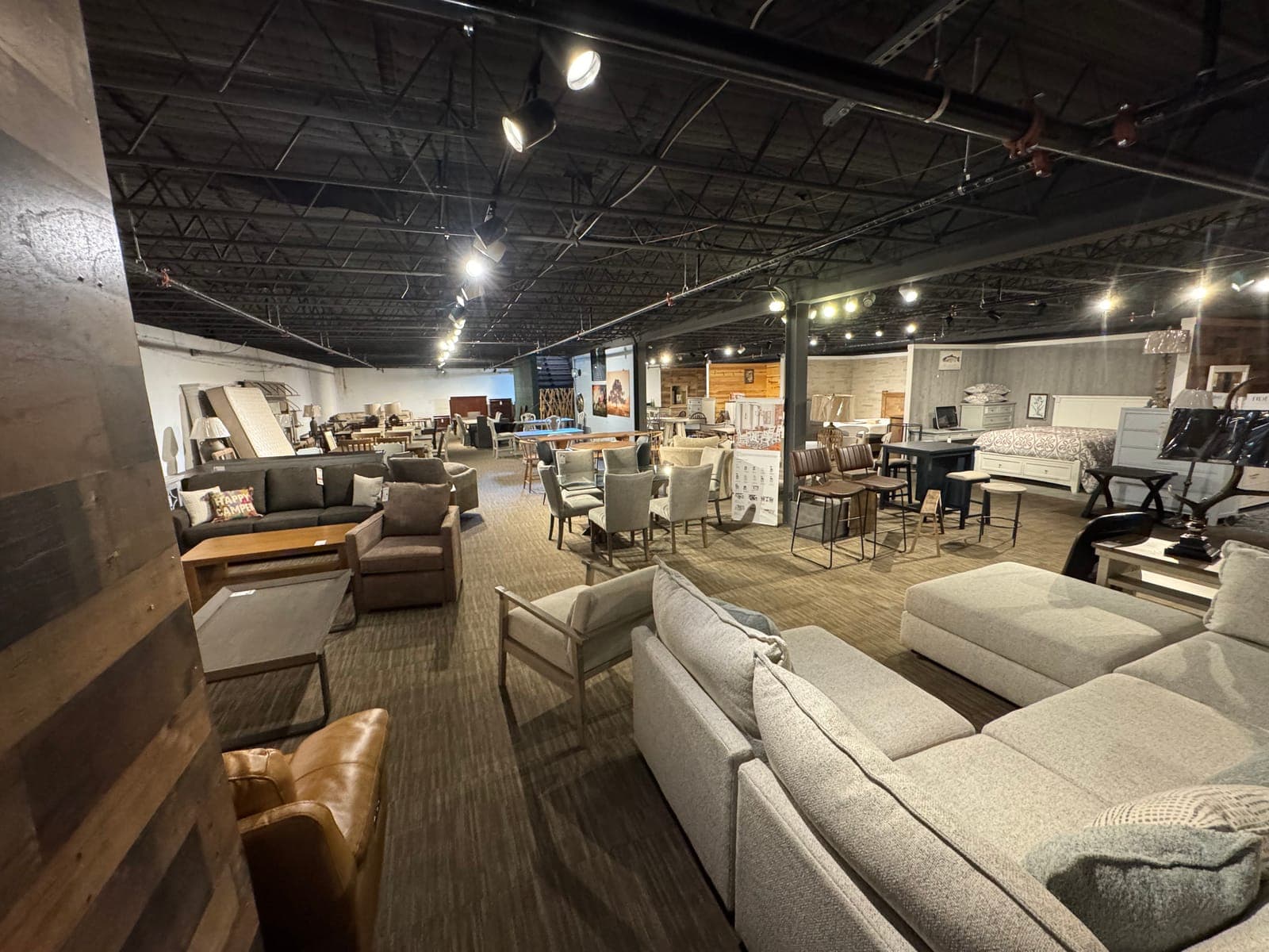 Wide view of the Seneca Furniture Showcase floor with upholstery, dining and bedroom collections